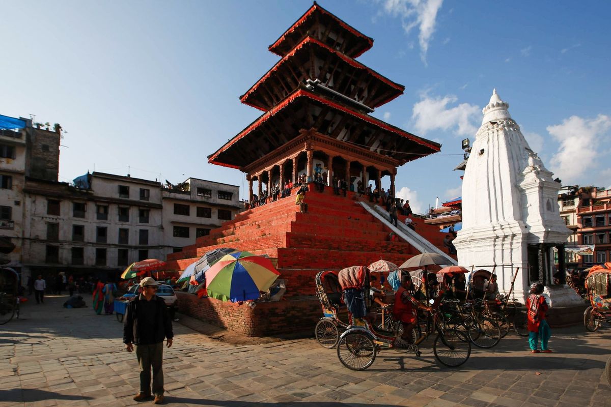 Maju Deval temple rising above Kathmandu's Durbar Square with cycle rickshaws waiting below