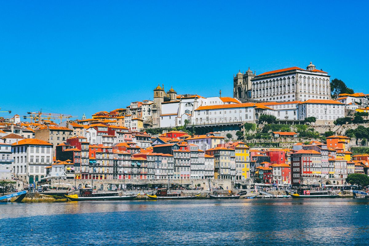 The colorful Ribeira district and Porto Cathedral rise above the Douro River waterfront.