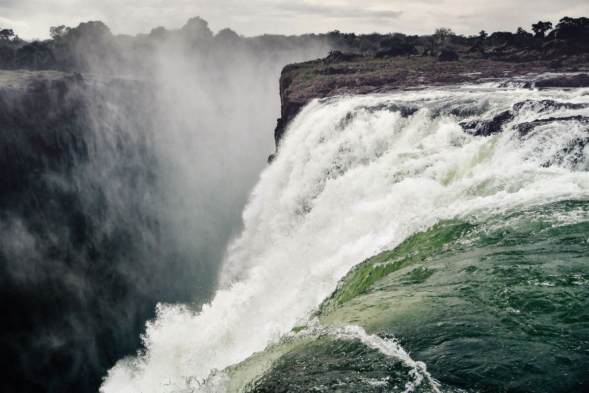 Torrential waters cascading over the edge of Victoria Falls on the Zambia-Zimbabwe border.
